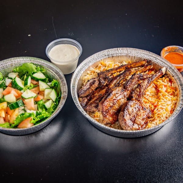 ichop Mediterranean lamb chops with rice, salad, and sauces in foil containers.
